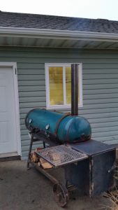 Homemade offset BBQ smoker cooking pulled pork in Buhl