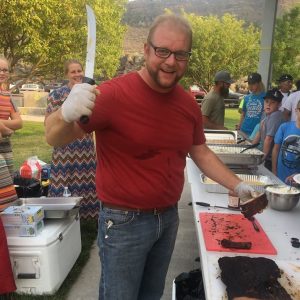 Dig In Barbecue serving BBQ ribs and brisket in Twin Falls at a company picnic.